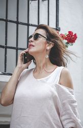 Confident woman calling on phone in town