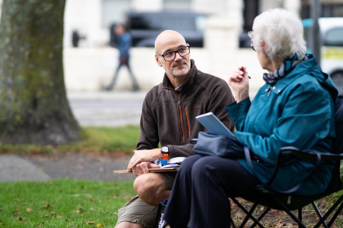 Woman sitting and walking with art instructor