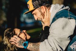 Happy young couple hugging in forest