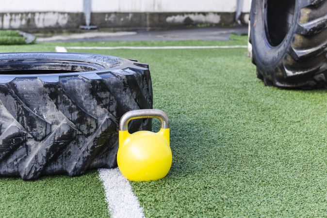 Heavy tires near kettlebell on lawn