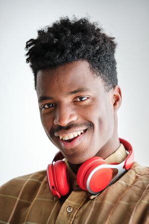 Content Black man with modern headphones on white background