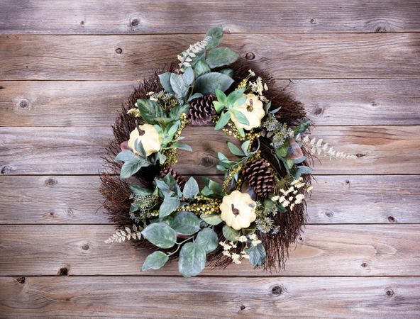 Autumn holiday wreath on rustic wood