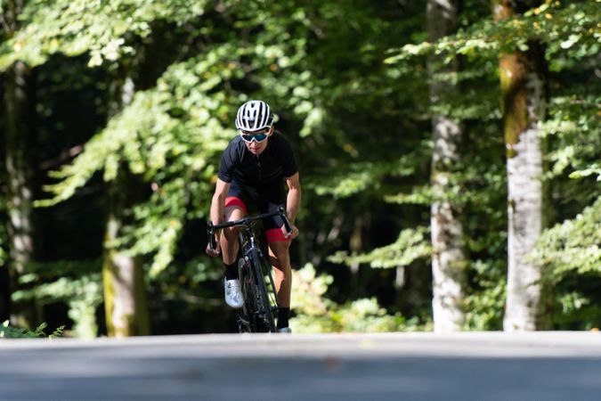 Professional cyclist riding bike in park