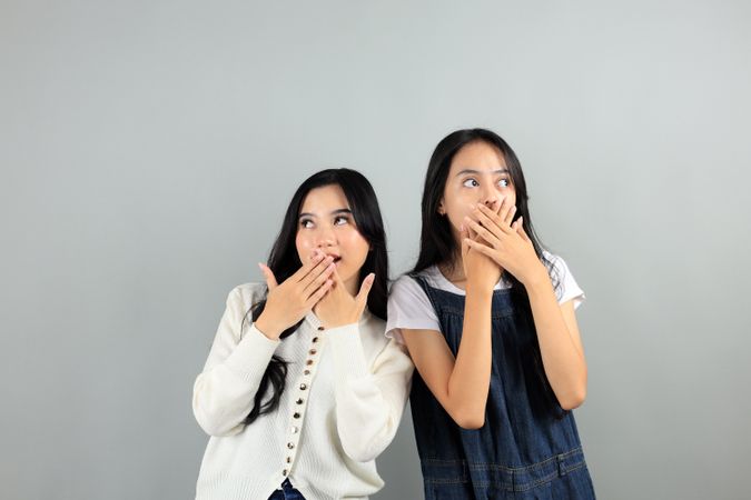 Two Asian Young Girl Shocked and Covering Her Mouth