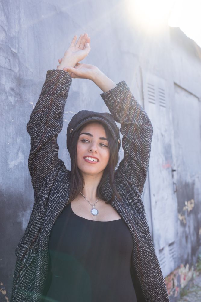 Charming Hispanic woman near wall