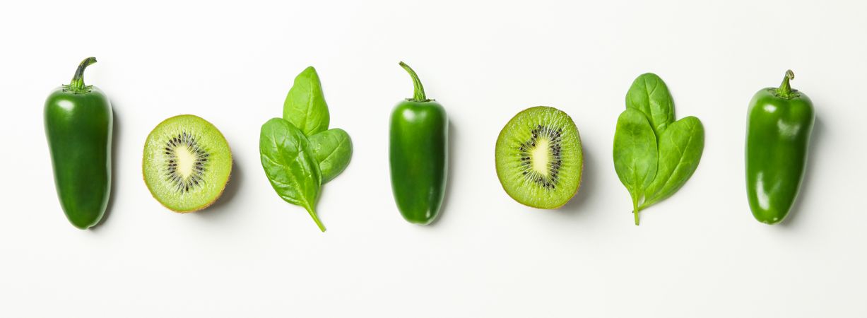 Kiwi, spinach and pepper on blank background