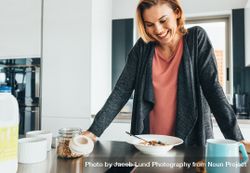 Smiling woman looking at breakfast bowl 4NeVr5