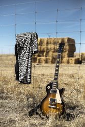 Guitar and striped jacket with barbed wire