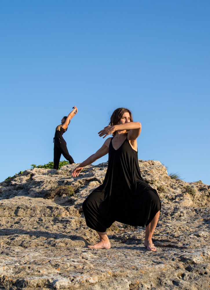 Women dancing near stones