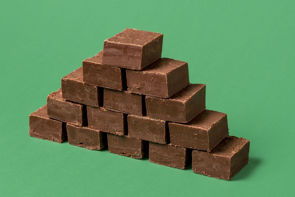 Chocolate fudge pile isolated on a green background