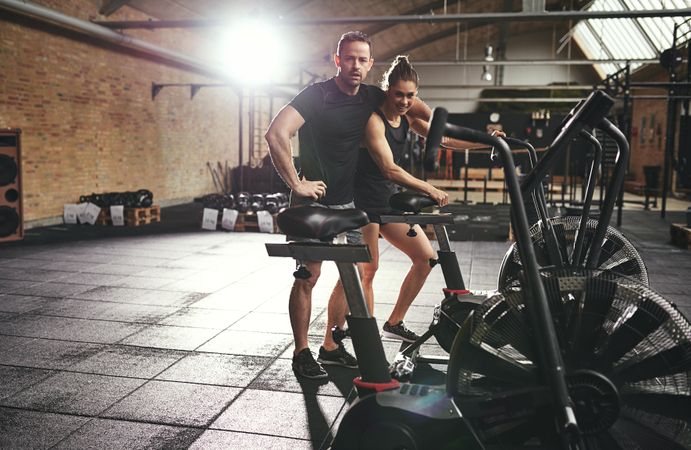 Tired man and woman after completing tough workout together