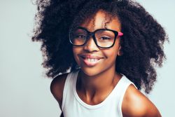 Studio portrait of confident girl wearing oversized glasses
