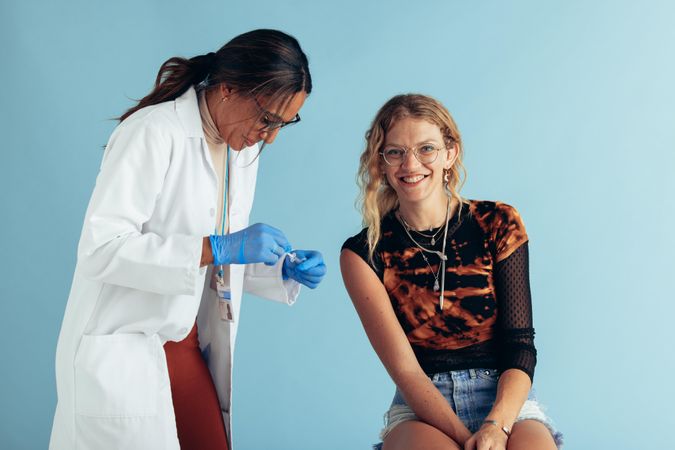 Young woman sitting at clinic to get a vaccine