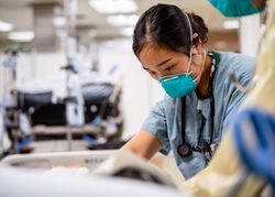 Los Angeles, California, USA - (April 16, 2020): Lt. j.g. Joyce Sim, treats a patient on USNS Mercy