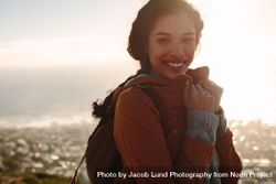 Portrait of woman smiling with bright sunshine on a winter day 4mNweb
