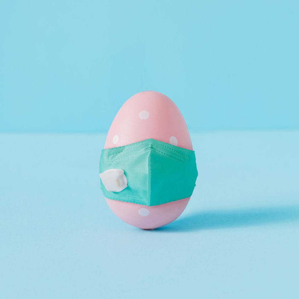 Pastel pink dotted Easter egg wearing face mask