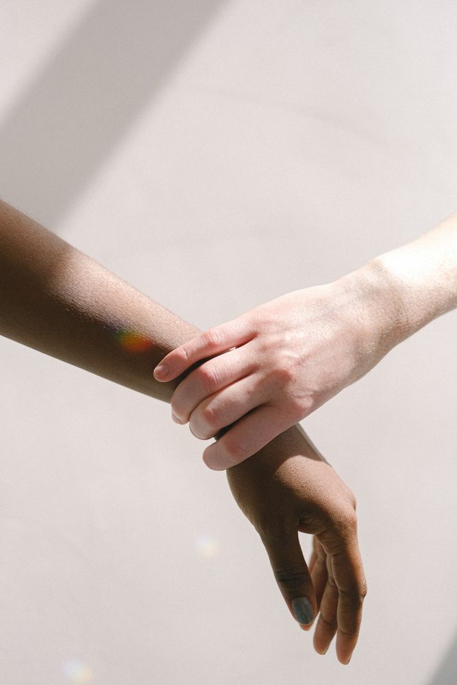One hand holding another hand