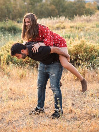 Happy couple having fun together in park