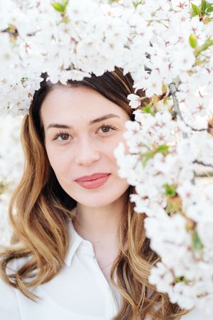 woman amidst white flowers