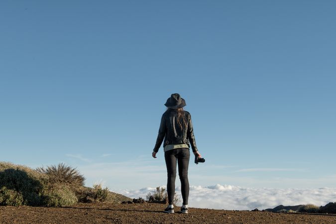 Woman with camera in desert
