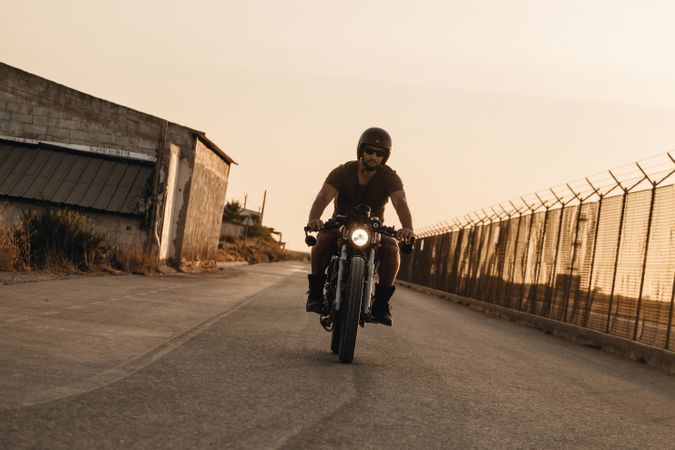 Strong man driving motorcycle