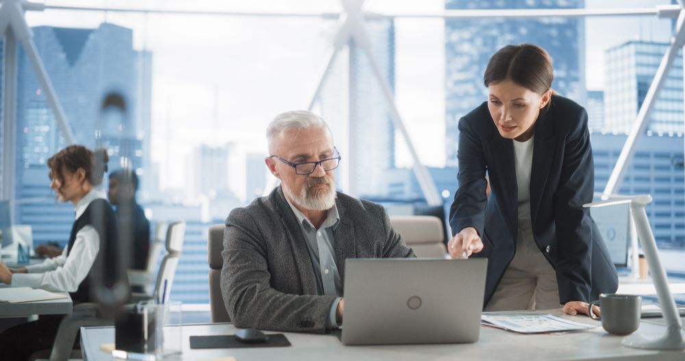 Man And Woman Looking For Investment Opportunities In Banking or Tech Sectors