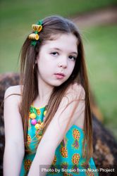 Portrait of young girl wearing yellow and green top 47Exa0