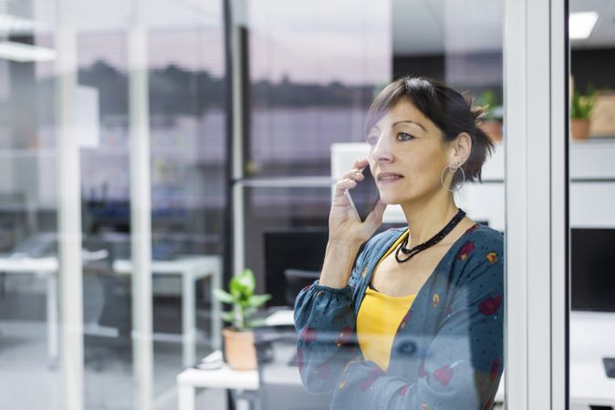 Woman browsing smartphone in office