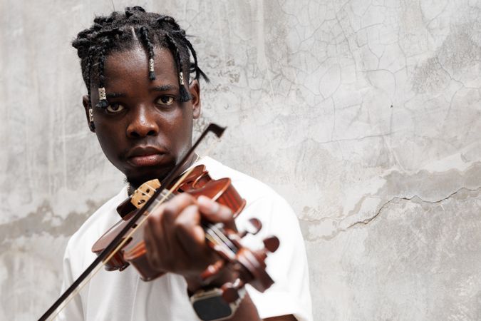Black male musician playing on violin.