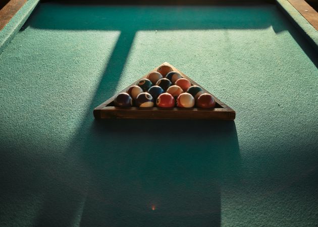 Looking down at triangle of pool table balls