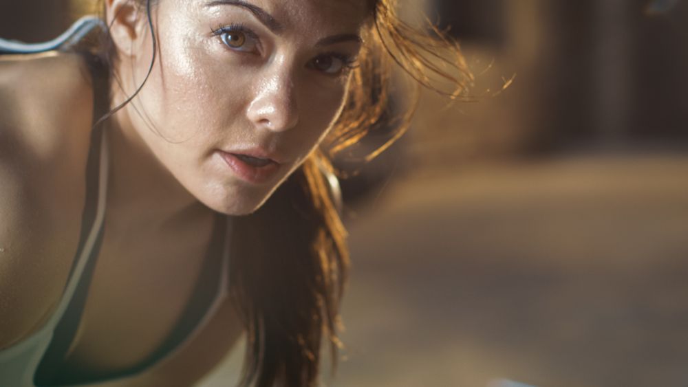Close-up Shot of a Beautiful Athletic Woman Looks into Camera.
