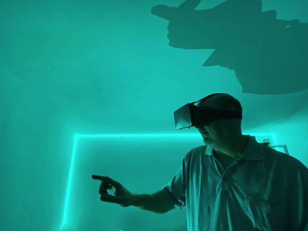Man wearing VR headset in green lit room