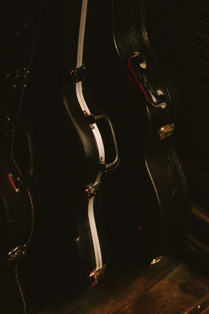 guitar covers on floor nearby wall