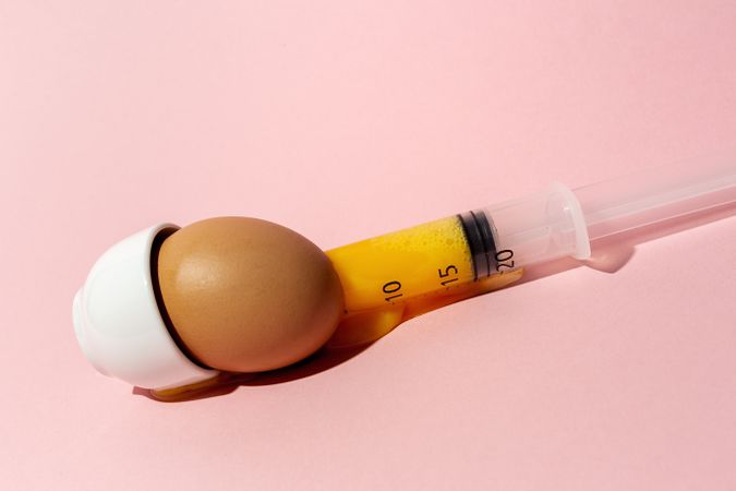 Egg with syringe in eggcup