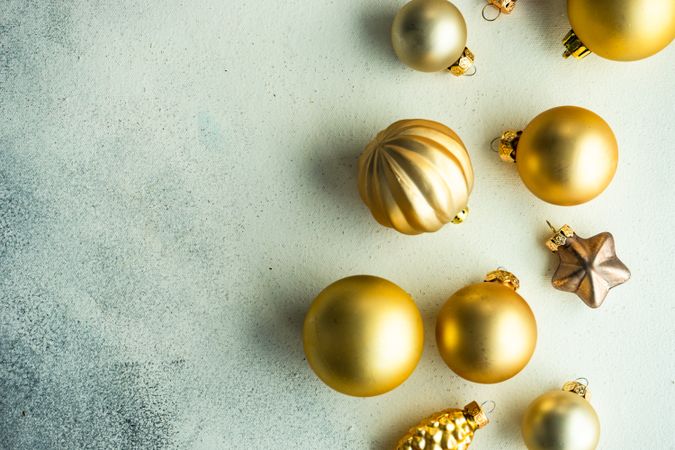 Golden Christmas decorations on marble table with copy space
