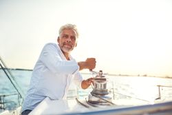 Man working on sailing yacht on bright day