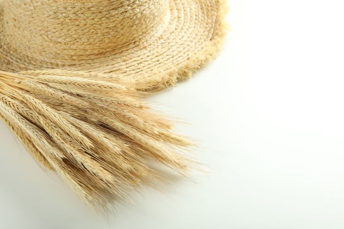 Dried bouquet of flowers next to thatch hat with copy space