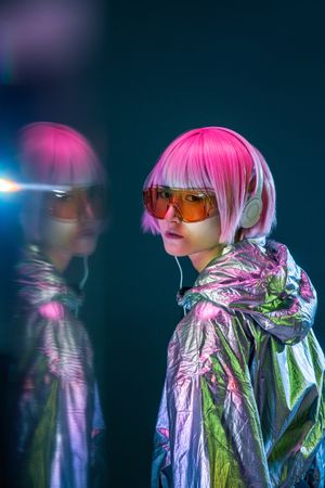 Fashionable Asian woman standing in silver jacket