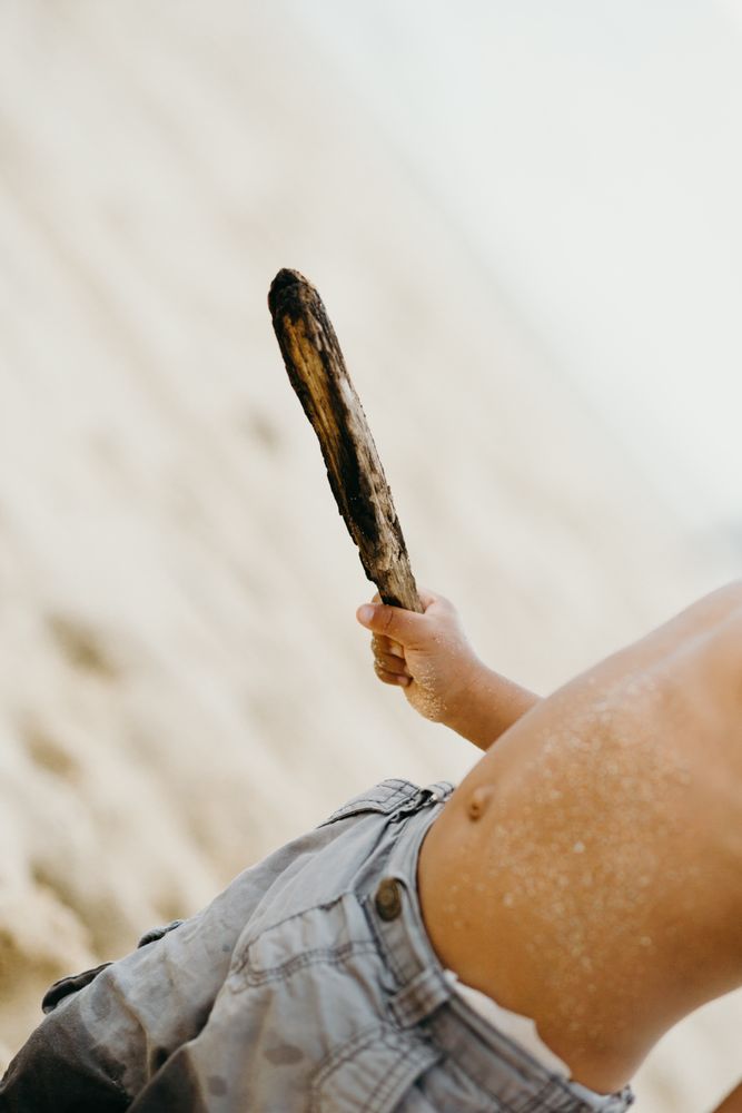 Crop Black boy playing on beach