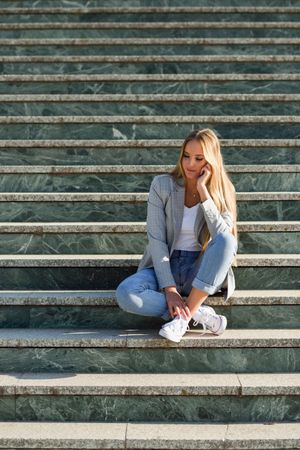 Woman sitting on steps in contemplation
