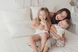 Content young mother with little kids at bedroom