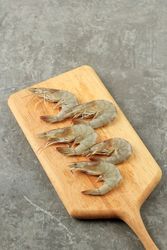Uncooked prawns on board being prepared before cooking