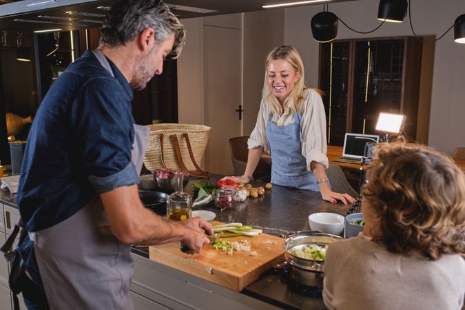 Family cooking dinner together at table