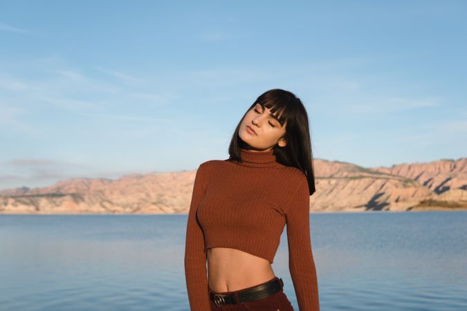 Sensual female standing near water