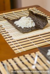Nori seaweed sheet with rice above ready to make Japanese sushi rolls, vertical be26E0