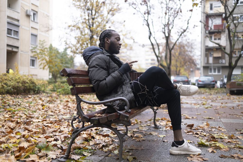Young Black Man Explaining During a Video Call in the Park with a Laptop