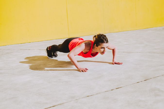 Woman doing plank exercises on floor