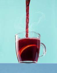 Pouring hot mulled wine into the cup