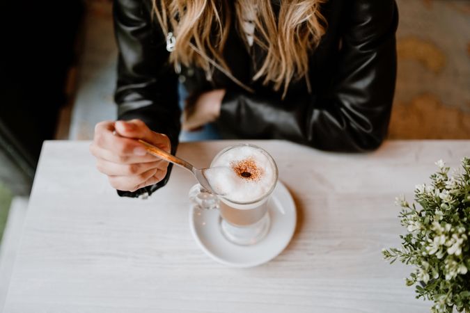 Woman drinking coffee from a glass