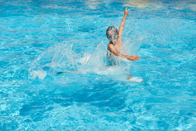 Kid jumping in swimming pool